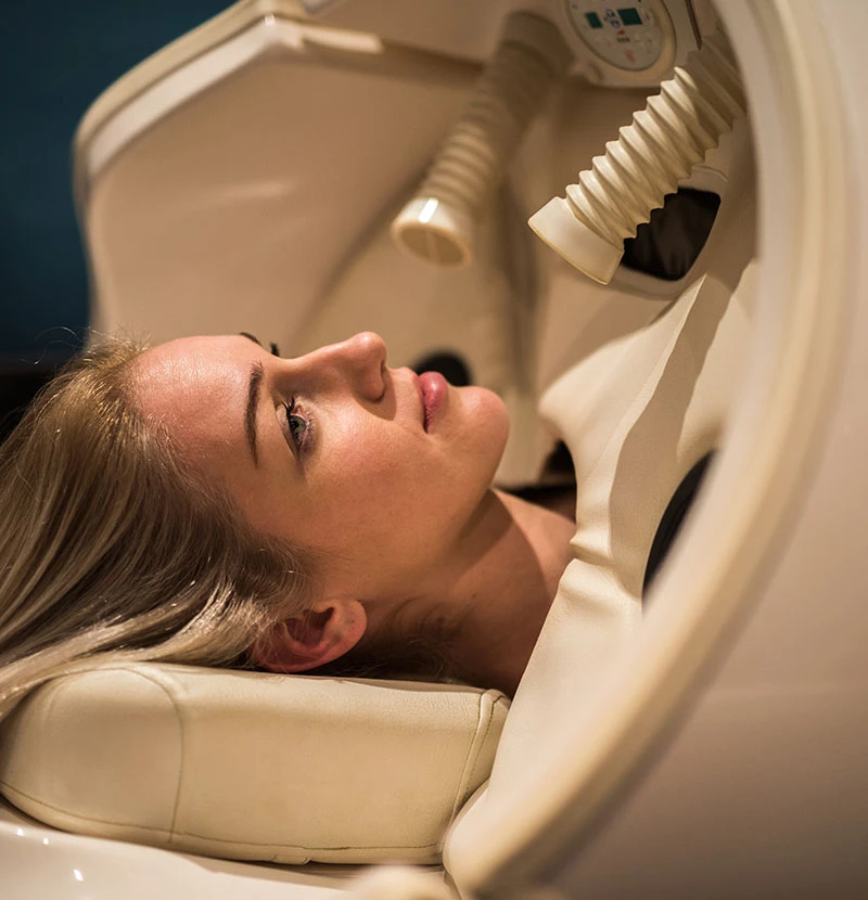 woman in hyerbaric oxygen chamber | Raggio Facial Plastic Surgery