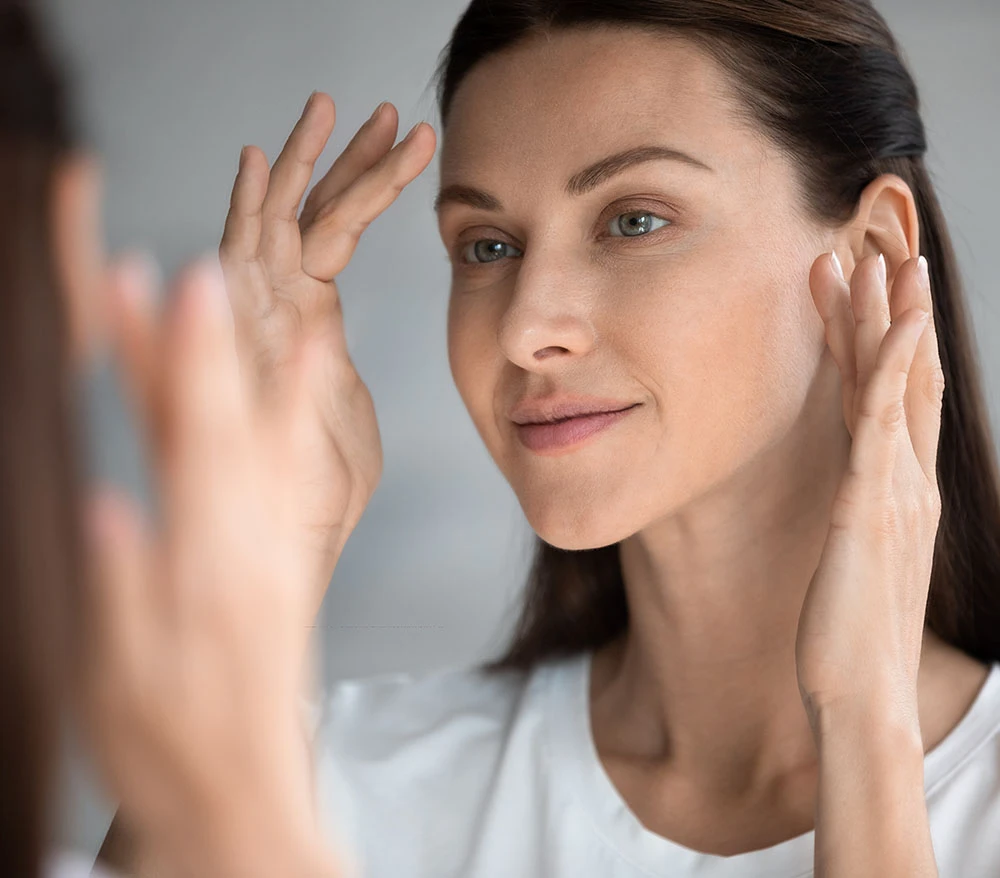 woman admiring chemical peel | Raggio Facial Plastic Surgery