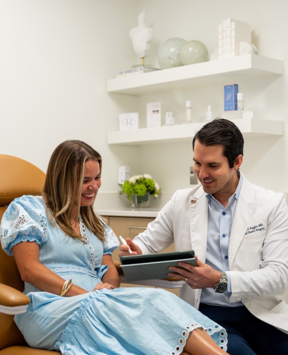 Dr. Blake Raggio consulting with a patient at Raggio MD Facial Plastic Surgery in Birmingham, AL.