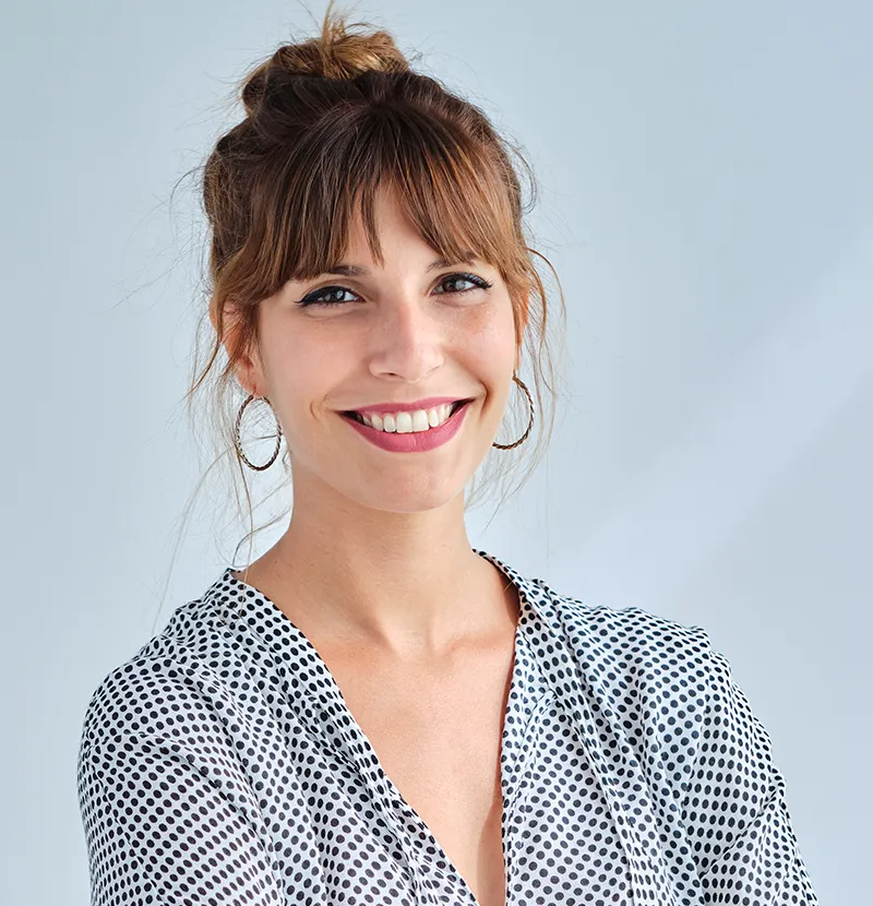 woman smiling in poka dot shirt